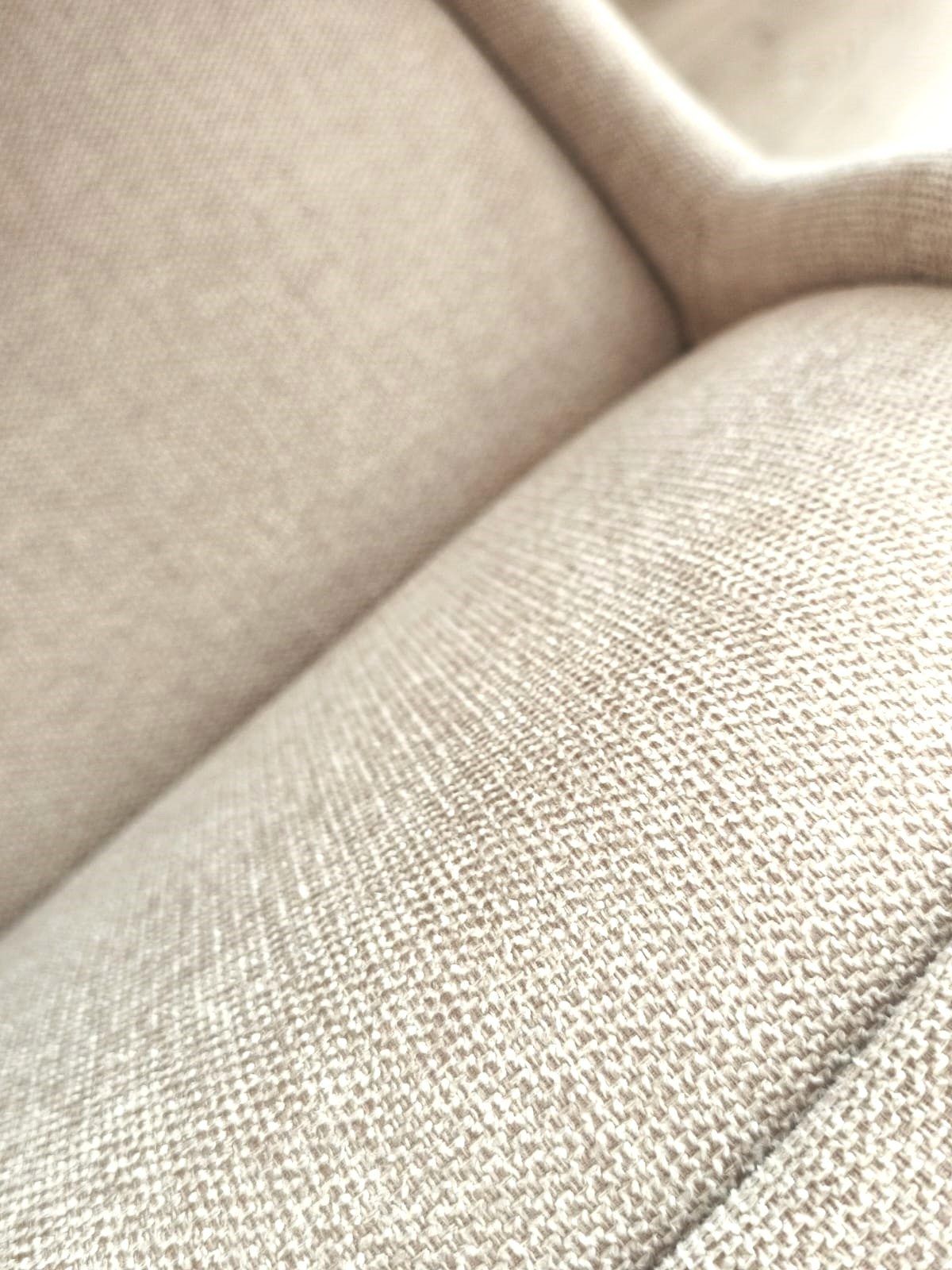 Detalle de un tejido de lino natural en un sofá claro